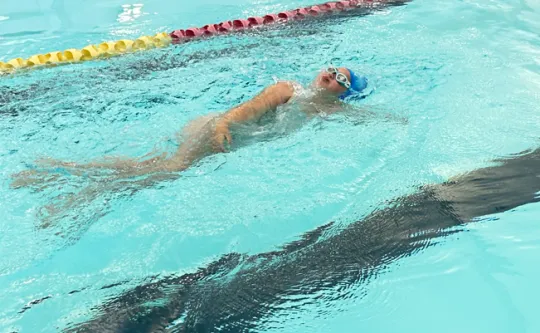 Young lady lane swimming using breast stroke