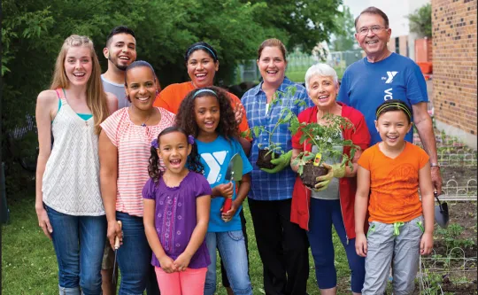 Group of people of varying ages working together in a garden