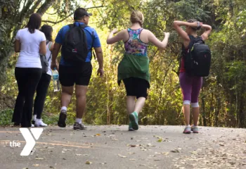 Group of people walking on a paved trail outdoors