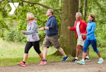 Senior adults walking as a group on a trail outdoors