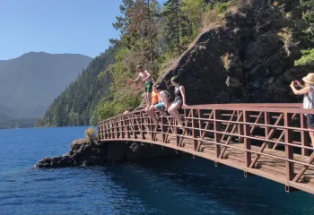 Youth and Seniors on Spruce Railroad Trail bridge over Lake Crescent, WA at Devil's Punchbowl