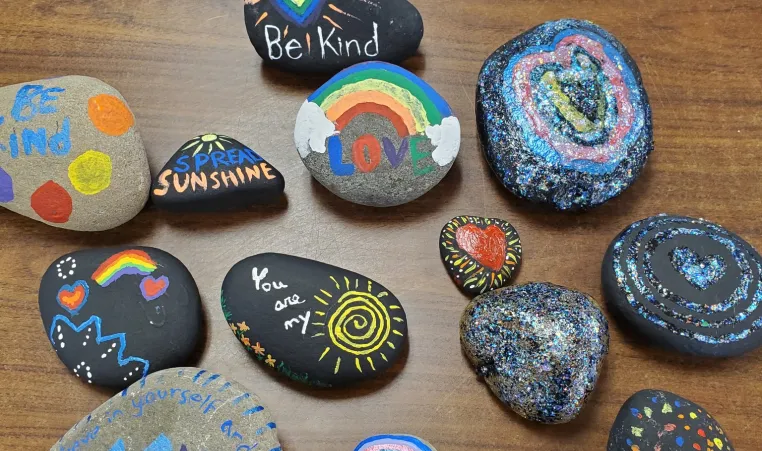 A variety of rocks painted with bright images