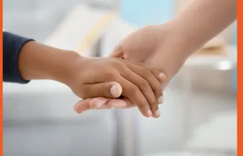 Image of a holding hands of a child and an adult.