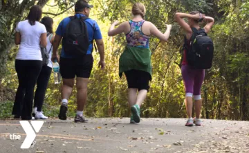 Group of people walking on a paved trail outdoors