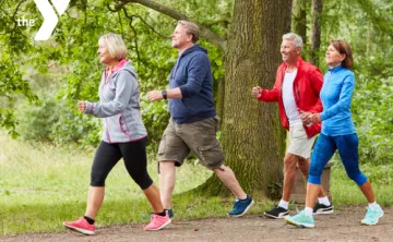 Senior adults walking as a group on a trail outdoors