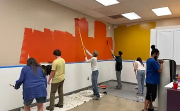 Teens and Y staff painting the walls of the new teen resource room