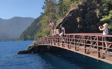 Youth and Seniors on Spruce Railroad Trail bridge over Lake Crescent, WA at Devil's Punchbowl