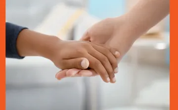 Image of a holding hands of a child and an adult.